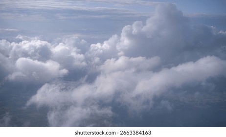 Airplane view above dramatic cloud layers