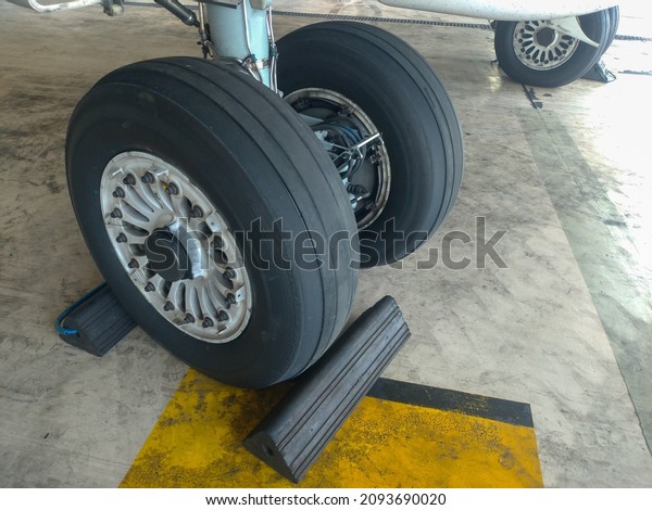 Airplane wheels with chocks on\
it.