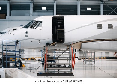 Airplane In A White Hangar For Maintenance