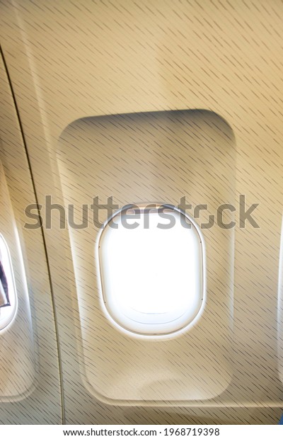 Airplane window with light\
coming in.