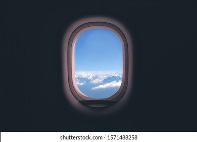 Airplane window. Mountain and clouds view - Shutterstock ID 1571488258