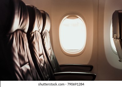 The Airplane Window And The Seat From The Inside.