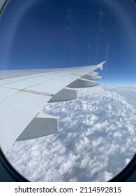 Airplane Window Seat View Above Clouds