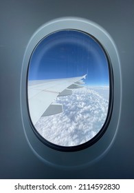 Airplane Window Seat View Above Clouds