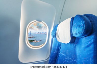 Airplane Window With View On Statue Of Liberty, New York.