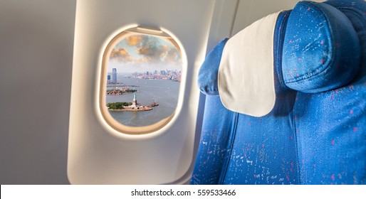 Airplane Window With View On Statue Of Liberty, New York.