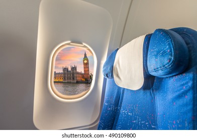 Airplane window with view on Westminster. Tourism concept.