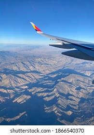 Airplane Window View While Flying Over Moutain Rage In USA