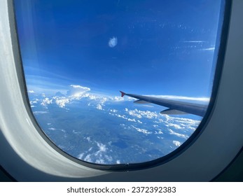 airplane window view White clouds blue sky - Powered by Shutterstock