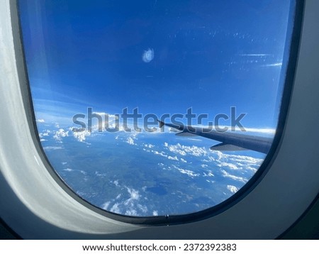 airplane window view White clouds blue sky