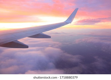 
Airplane wing above the cloud at dawn