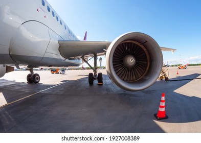 Airplane wing with engine, view under the plane during flight service