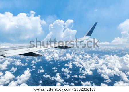Airplane wing and sky cloudscape in stratosphere