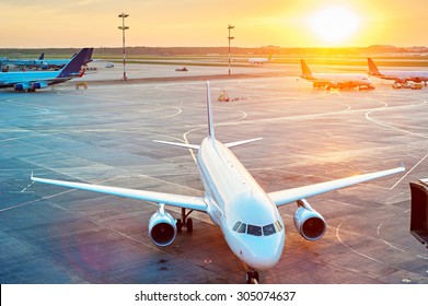 Airplanes In The Airport At Sunset. View From Above