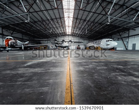 Airplanes in a Hangar with yellow line