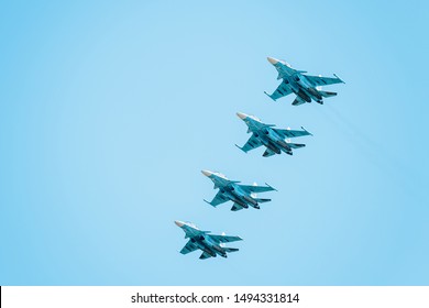Airplanes with white smoke traces on air show. Pilots make tricks on Airforce jets at blue sky background.
