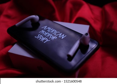 Airpods 2 And Iphone 11 Pro With The American Horror Story Logo Which Is A Drama And Horror Television Series. United States, New York, Thursday, October 3, 2019.