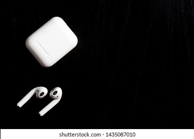 Airpods With Charging Case On Black Textured Background 