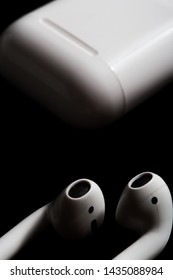 Airpods With Charging Case On A Black Background