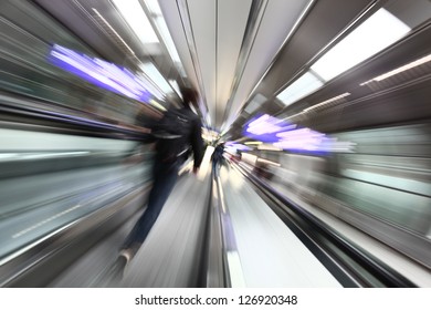 Airport abstract background. Man goes on the escalator. Blurred movement.