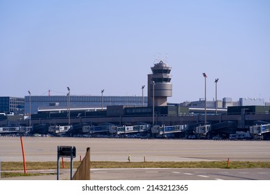 Zürich Airport with airtraffic control tower on a blue cloudy spring day. Phot taken March 26th, 2022, Zurich, Switzerland.