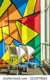 Airport Cart In Corner And Colorful Door Background For Passenger 