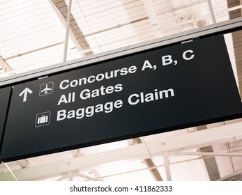 Airport concourse, gates, and baggage claim sign - Shutterstock ID 411862333