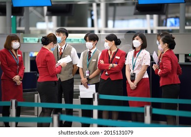  Airport Departures Terminal, HongKong-18July2021:last Day Of LOTR Leave Outside The Rules,
Airline Stewardess, Flight Attendant ,Cabin Crew With Mask On Face And Red Uniform, Working In Busy Schedule