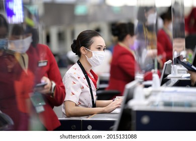  Airport Departures Terminal, HongKong-18July2021:last Day Of LOTR Leave Outside The Rules,
Airline Stewardess, Flight Attendant ,Cabin Crew With Mask On Face And Red Uniform, Working In Busy Schedule