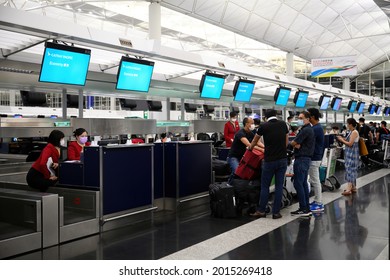 Airport Departures Terminal, HongKong-18July2021:last Day Of LOTR Leave Outside The Rules,
Airline Stewardess, Flight Attendant ,Cabin Crew With Mask On Face And Red Uniform, Working In Busy Schedule