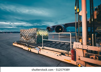 Airport At The Dusk. Loading Of Cargo To The Freight Aircraft.