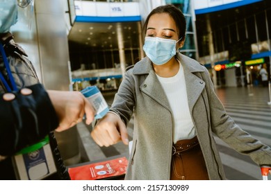 Airport Employee Measuring Temperature Of Indian Woman In Airport Indoors