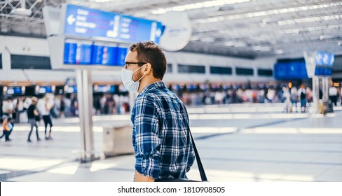 Airport European Nerd Man In Glasses And Plaid Shirt With Luggage Tourist Boarding Plane Taking A Flight  Wearing Face Mask. Coronavirus Flu Virus Travel 