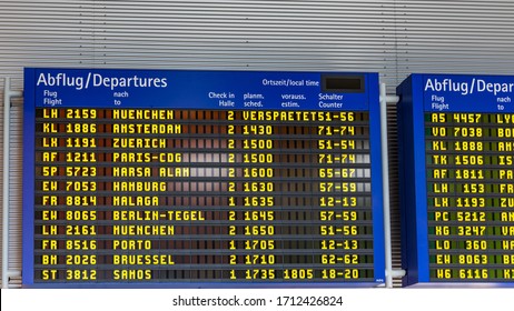 Airport Flight Information Displayed On Departure Board, Flight Status Changing. Flight Schedule Screen At Airport Showing Different Destinations. 