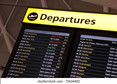 Airport flight information on a large screen international departure board - Shutterstock ID 72634402
