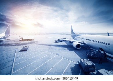 Airport with many airplanes at beautiful sunset