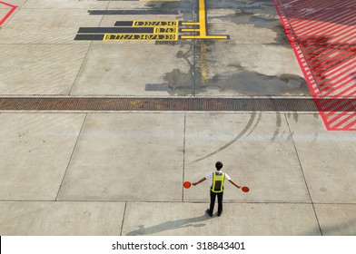 Airport marshalling signal from marshaller for aircraft controls.

Ground Crew Signals

Airport Ground Crew Outfit and Signals

A ground crew  signals the pilot