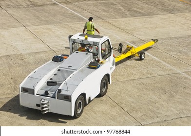 Airport Personnel Ground Support On Tarmac In Their Truck