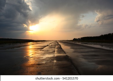 Airport Runway After Rain During Sunset.