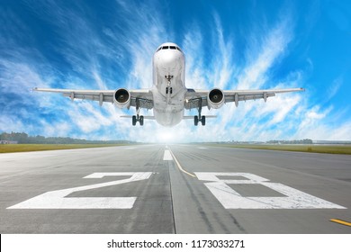 Airport Runway Number 28 And Airplane Take Off To In Horizon And Picturesque Cirrus Clouds In The Blue Sky