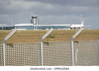 Airport Runway With A Plane Touching Down