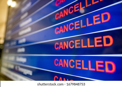 Airport screen indicating cancelled flights due to the Coronavirus pandemic  - Shutterstock ID 1679848753