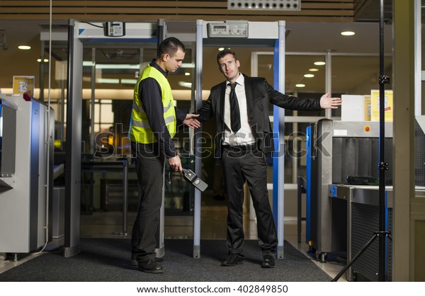 Airport security check at gates with metal detector and\
scanner 