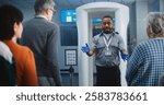 Airport Security Checkpoint: African American Security Officer Gives Instructions to Diverse People, Passengers About TSA Screening Procedures for Boarding Flight. Tourists Going on Vacation Trips.