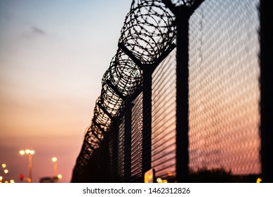 Airport Security Fence After Sunset