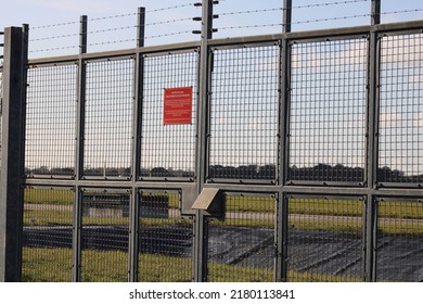 Airport security fence with warning sign