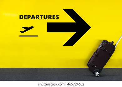 Airport Sign With Airplane Icon, Arrow And Moving Luggage On Yellow Wall