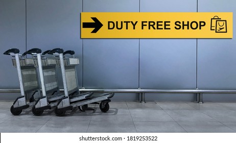 Airport Sign for Duty Free Shop inside the Terminal Building. Travel and Transportation Concept. Blurred Baggage Carts as foreground