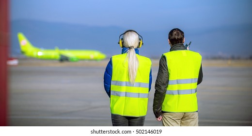 Airport Staff Looking At Aircraft