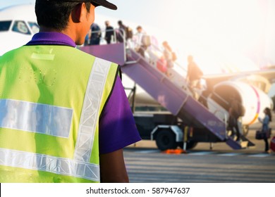 Airport Staff Looking At Aircraft